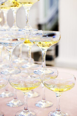Pyramid of empty and filled with champagne glasses