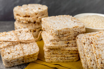 puffed rice bread on black texture background. Healthy crunchy snack. Whole grain crispy bread. Healthy food. Diet. Copy space. Place for text.