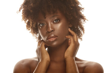 African american girl touching her soft flawless skin on face.