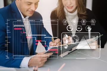 Business team hand Project manager working and update tasks and Gantt chart scheduling virtual diagram with tablet and laptop in office.