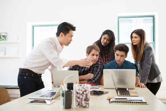 Businessman explaining strategy to colleagues in creative office