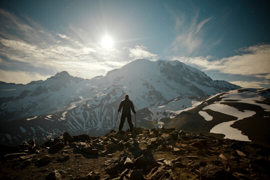 Hiker watches the Moon rise over the NE face of Mount Ranier.