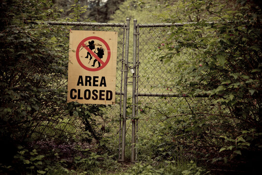 Locked gate with area closed sign.