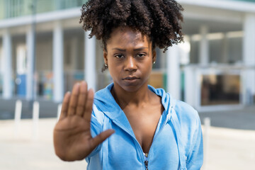 Black woman gesturing stop agains racism - obrazy, fototapety, plakaty