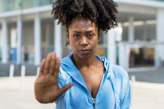 Black woman gesturing stop agains racism