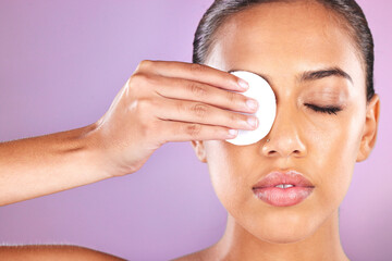 Skincare, beauty and woman with cotton pad in studio for wellness, dermatology and facial treatment. Spa aesthetic, luxury cosmetics and face of Latina girl for cleansing, hygiene and makeup removal