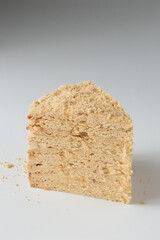 Piece Of Layered Homemade Honey Cake on the white table