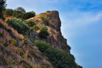 A mountain top with a clear sky and various dwarf Mediterranean scrub plants
