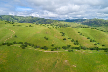 Upper Cottonwood Creek Wildlife Area. Beautiful Nature and Landscape. Green area with Cloudy Sky. Close to San Luis Reservoir. California, USA. Drone