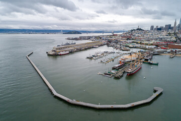 Aquatic Park Pier , Cove and Municipal Pier in San Francisco. Maritime National Historic Park in Background. Cityscape of San Francisco. California. Drone