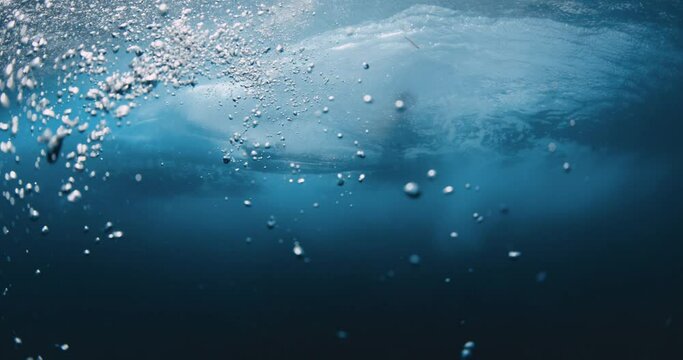 Underwater wave. Transparent water and breaking barrel wave with bodyboarder