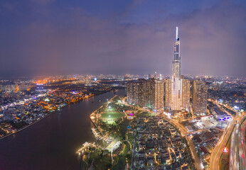 HOCHIMINH CITY, VIETNAM - JANUARY 8, 2022: Aerial photo evening at District 1, view to landmark 81, see Hanoi highway, Saigon bridge and metro under construction. Nearby is Vinhomes Central Park.