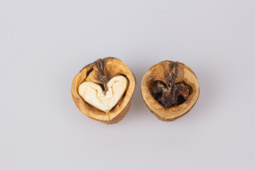 Half a walnut with a heart shape in the middle. The concept of love for nuts. Good and evil. Valentine's Day.