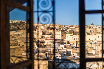 Fez medina seen through riad's window with decorative grate, Morocco, Africa