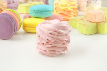 Assorted of sweets: macaroons, marshmallows and zephyrs. Homemade colored desserts for the present.