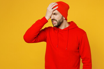 Young mistaken sad ashamed caucasian man wear red hoody hat put hand on face facepalm epic fail...