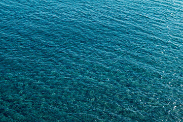 Fototapeta na wymiar Clear blue waters of Aegean Sea on Tinos island, Cyclades, Greece