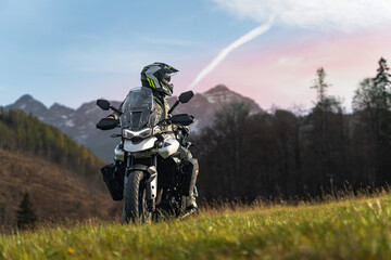 Motorcycle rider in mountains during sunset
