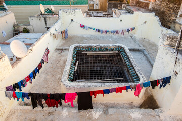 Drying clothes on the rooftop terrace of a traditional house in Arabic medina of Fes, Morocco,...