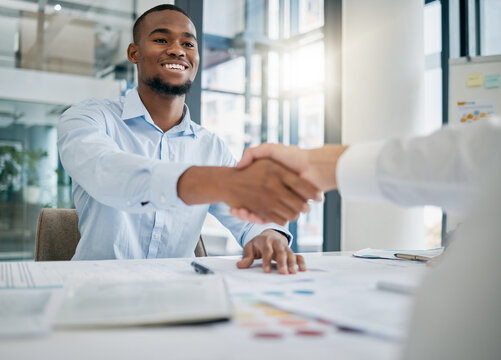 Hiring, designer or black man shaking hands with human resources manager for a successful job interview in office. Handshake, meeting or worker with a happy smile for a job promotion or business deal