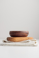 Empty tableware - wooden plate bowl with a towel on white table as a background for a dish foodbackground