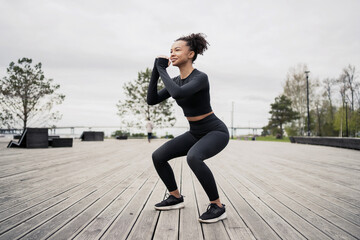 Fitness woman workout jumps outdoors in urban environment