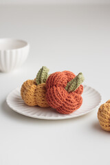 Crocheted pumpkins on a white table