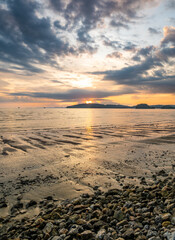 Beautiful sunset with dramatic clouds and sky of blue and orange color. Ao Nang beach, Krabi town,...
