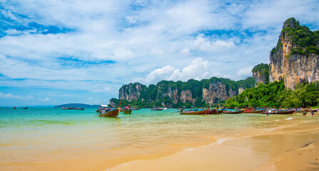 Long tail boats at Railay beach, Krabi, Thailand. Tropical paradise, turquoise water and white sand.