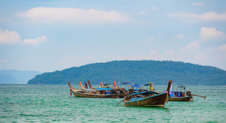 Fototapeta na wymiar Long tail boats at Railay beach, Krabi, Thailand. Tropical paradise, turquoise water and white sand.