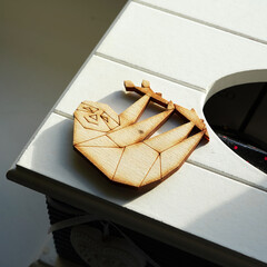 Wooden brooch in the shape of a sloth.