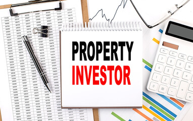 PROPERTY INVESTOR text on notebook with chart, calculator and pen