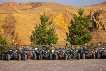 ATVs in the parking lot are rented in the recreation area. Quad bike and equipment. Extreme...