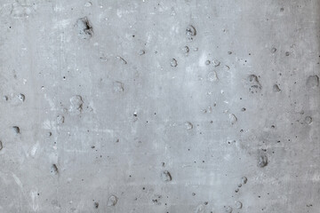 Raw and uneven concrete wall surface.