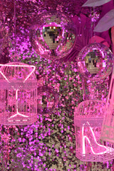Disco ball and pink cages with neon light