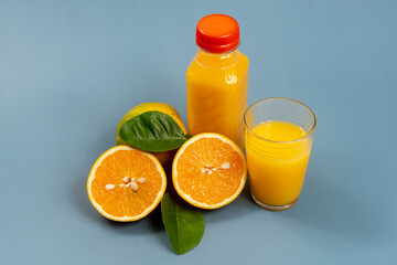 Natural orange juice in the glass with bottle on the side
