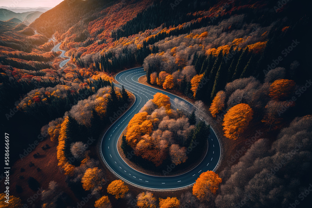 Canvas Prints Aerial picture of a mountain road at dusk amid a lovely woodland in the autumn. Drone aerial image of a winding road in the woods. Beautiful scenery with a curvy road and trees that have orange leaves