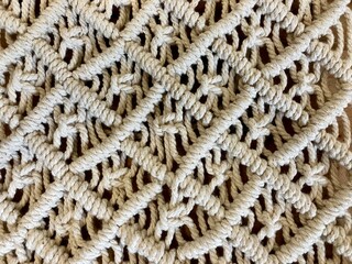 hand made macrame texture pattern. ECO friendly modern knitting DIY natural decoration concept. Flat lay.