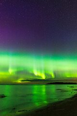 Northern lights reflected in water. Nykarleby/Uusikaarlepyy, Finland.