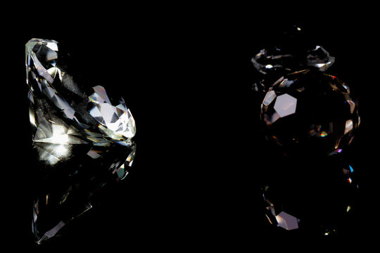 real glas objects with shadows and light refraction formed as diamond and others isolated on black background
