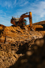 Excavator digging out rocks in a quarry 