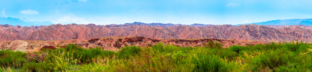 Natural unusual landscape of red rocks against the backdrop of blue mountains. The extraordinary...