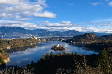 View of lake Bled and the island on the lake with church of the assumption and Bled castle and Karavanke mountains