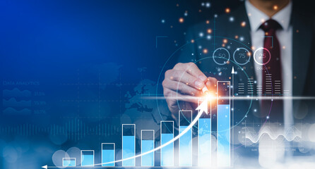 Obraz premium Businessman using pen touch bar graph of analytics and financial, Changes in new planning, Business growth, ideas and perspectives, Stock investment, and dividends yield from business in the new year