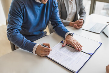 Picture of a diverse couple, starting a business, signing a lease.