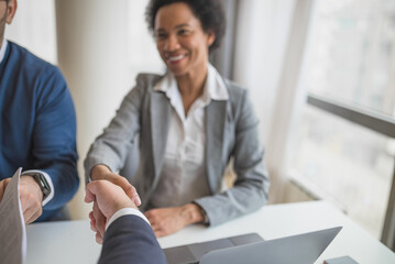 Lovely african american businesswoman, greeting her manager.