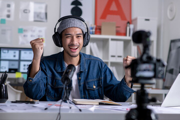 Young Asian male graphic designer blogger influencer talking looking at camera shooting education...