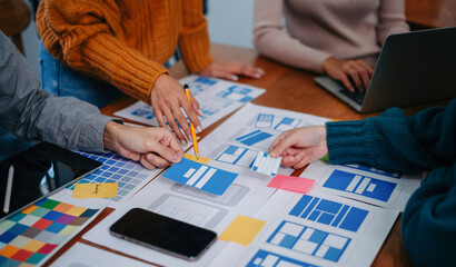 UX developer and ui designer brainstorming about mobile app interface wireframe design with...