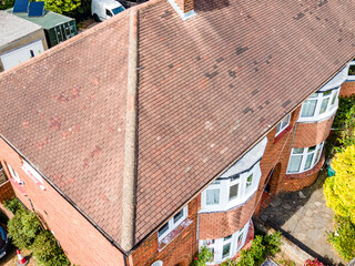 Typical 1930's British semi detached house aerial view of the original pitched timber roof with...