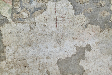 Old rustic grungy aged painted facade of rusty smudged daub. Rough grime edged wall. Wrinkled uneven plastering. Cracked chipped messy falling stucco.Dirty vintage flaking textured layer for 3D design